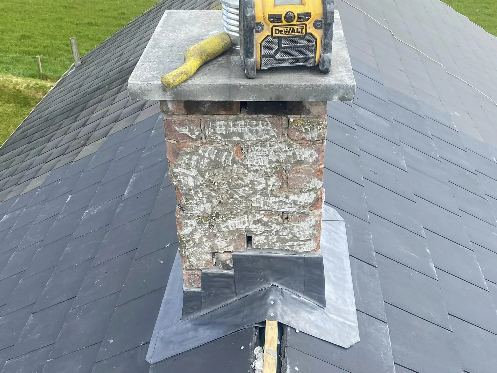 Chimney stack with new lead flashing on a slate roof