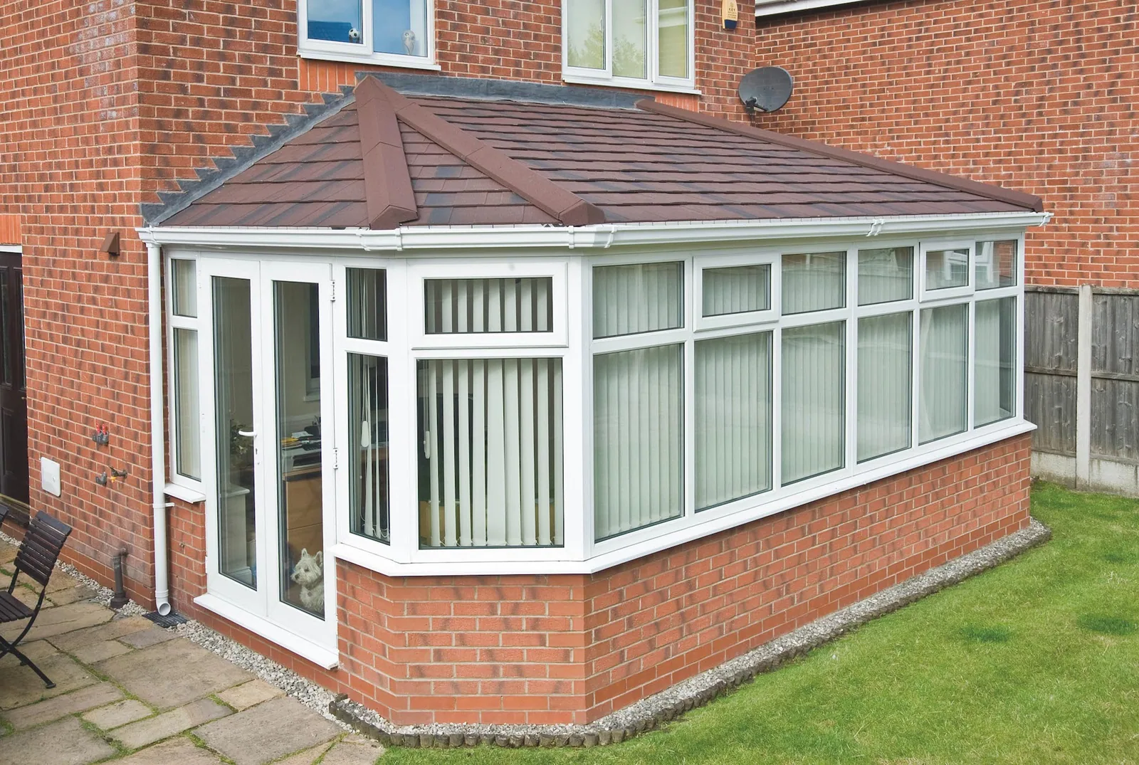 White UPVC conservatory with a solid tiled roof