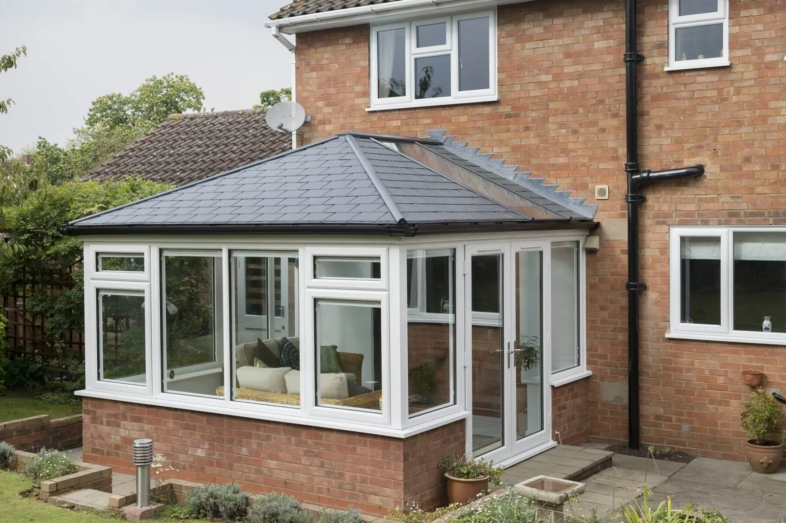 Conservatory with grey warm roof on a UK semi-detached home