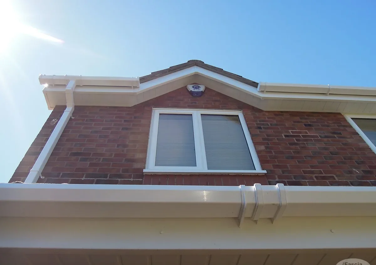 New white UPVC fascia and guttering on a UK brick house