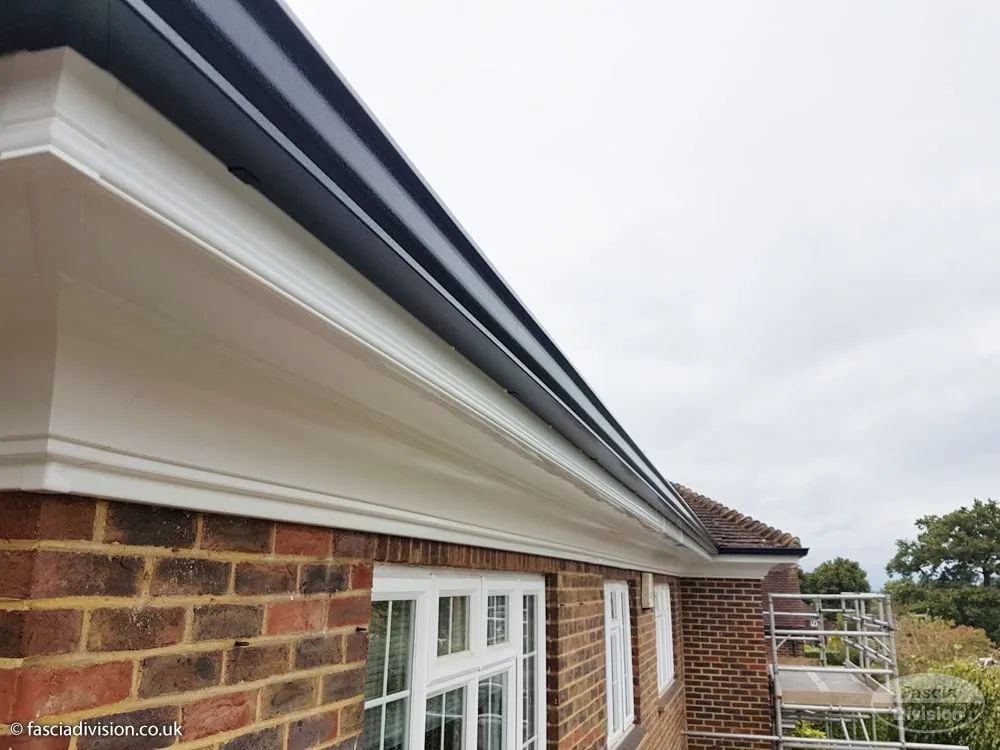 Flat soffit with continuous guttering on a British property