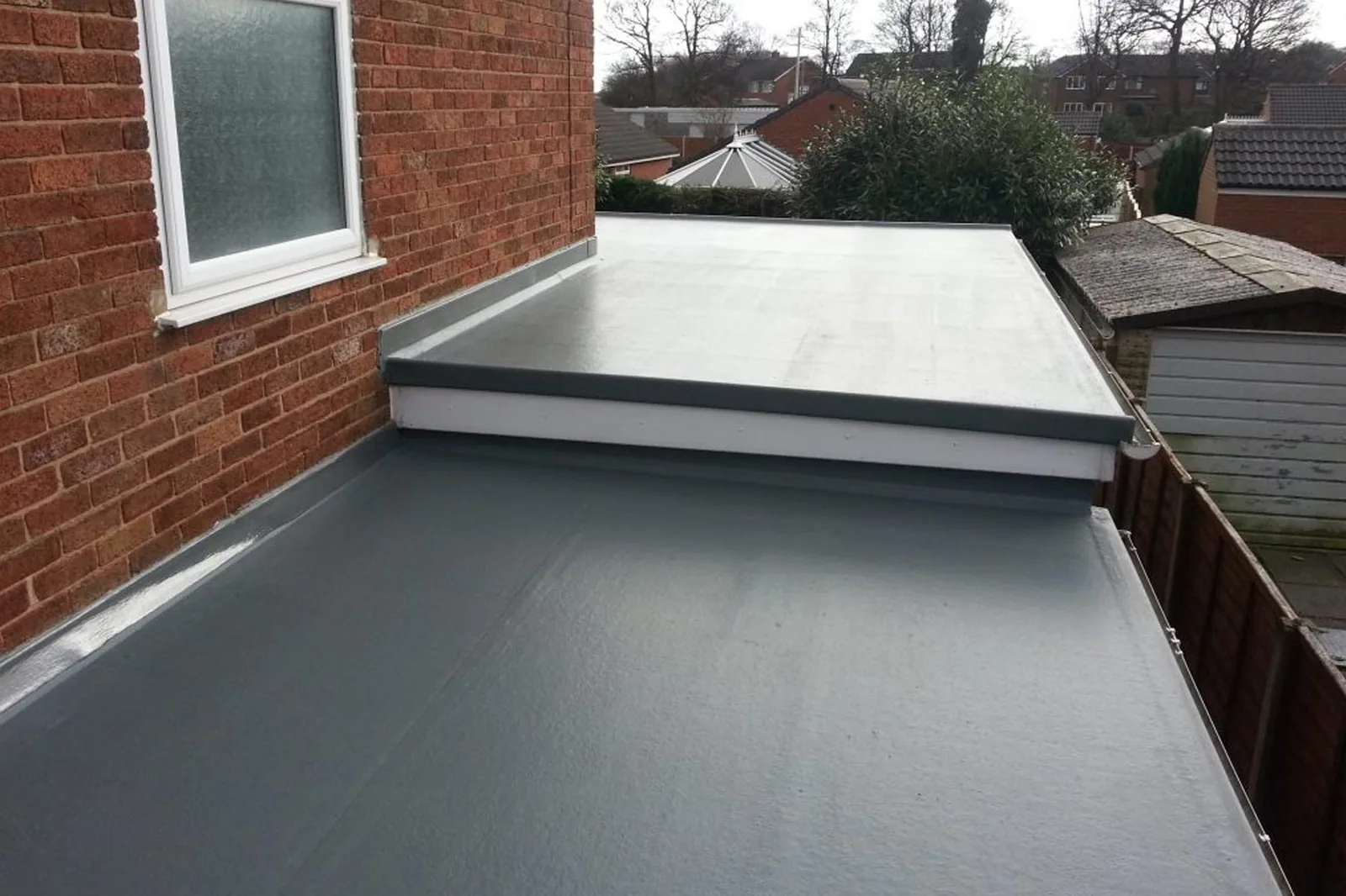 New grey EPDM rubber flat roof on a British extension