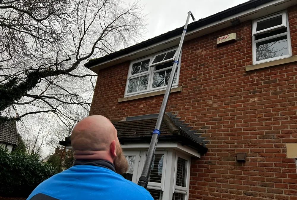Gutter cleaning with a high reach vacuum pole at a UK house