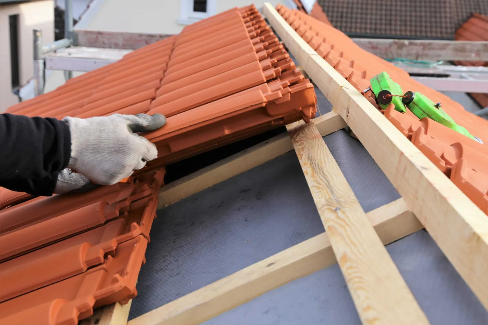 New clay roof tiles being fixed to treated timber battens