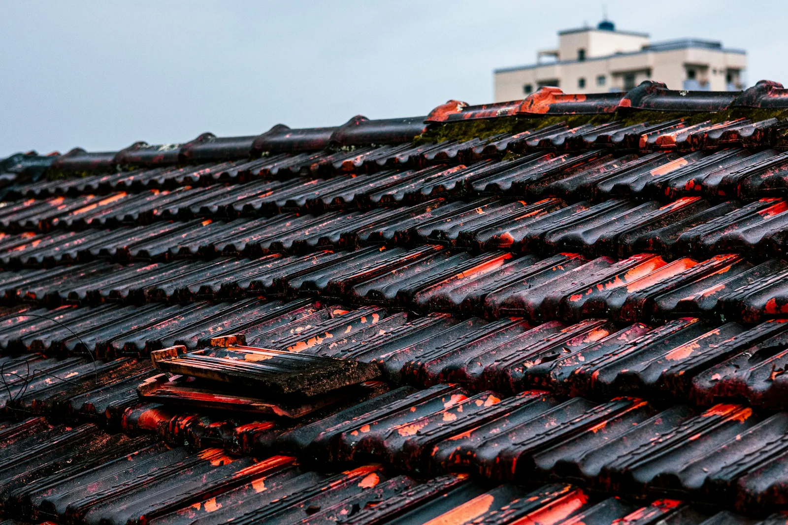 Replacement roof tiles being fitted to a UK pitched roof