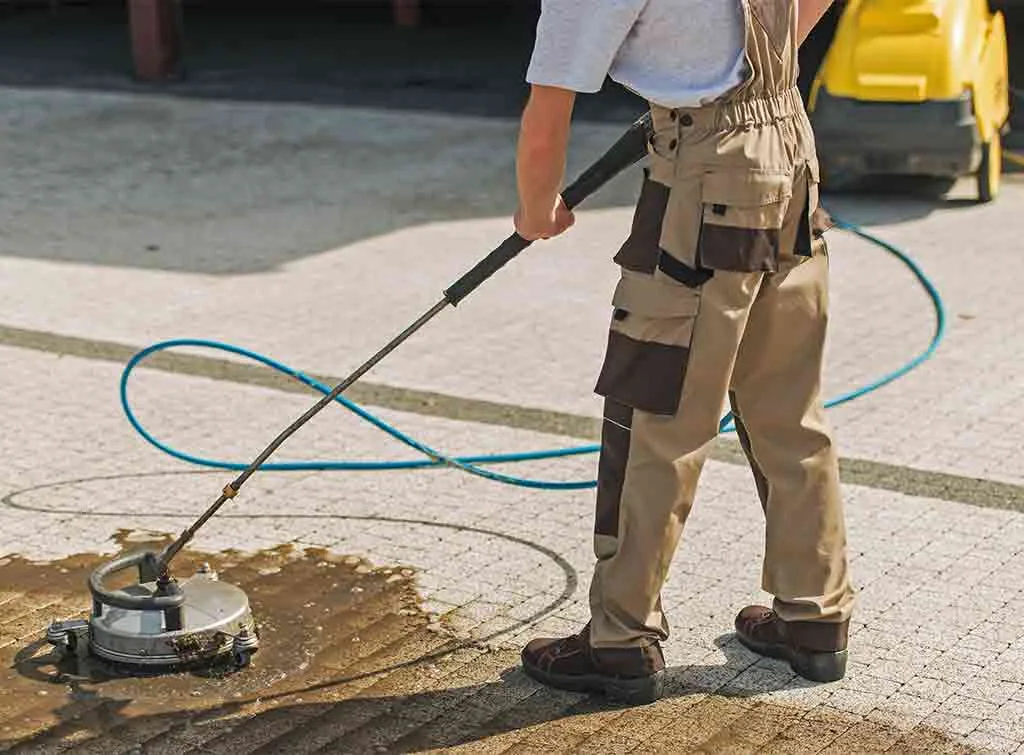 Driveway being pressure washed at a British home