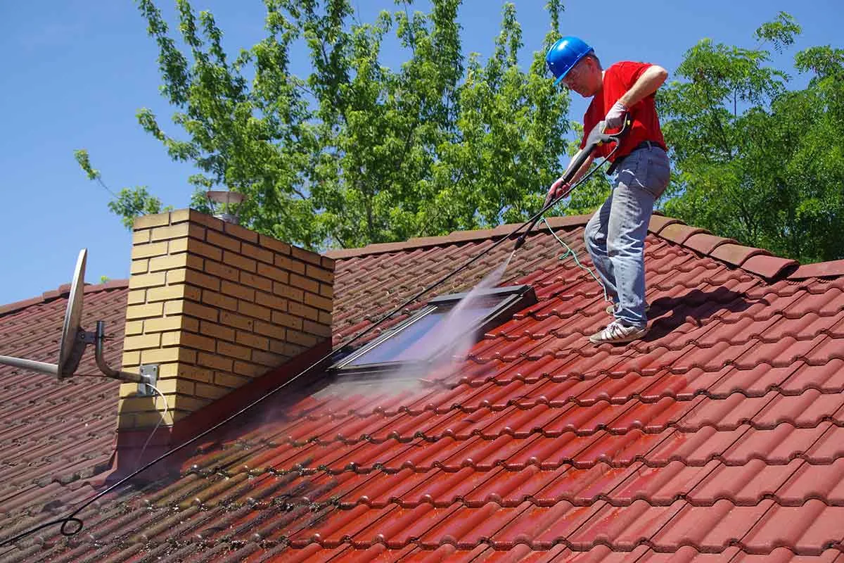 Roof tile cleaning in progress on a UK house